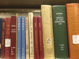 Row of international law books on shelf